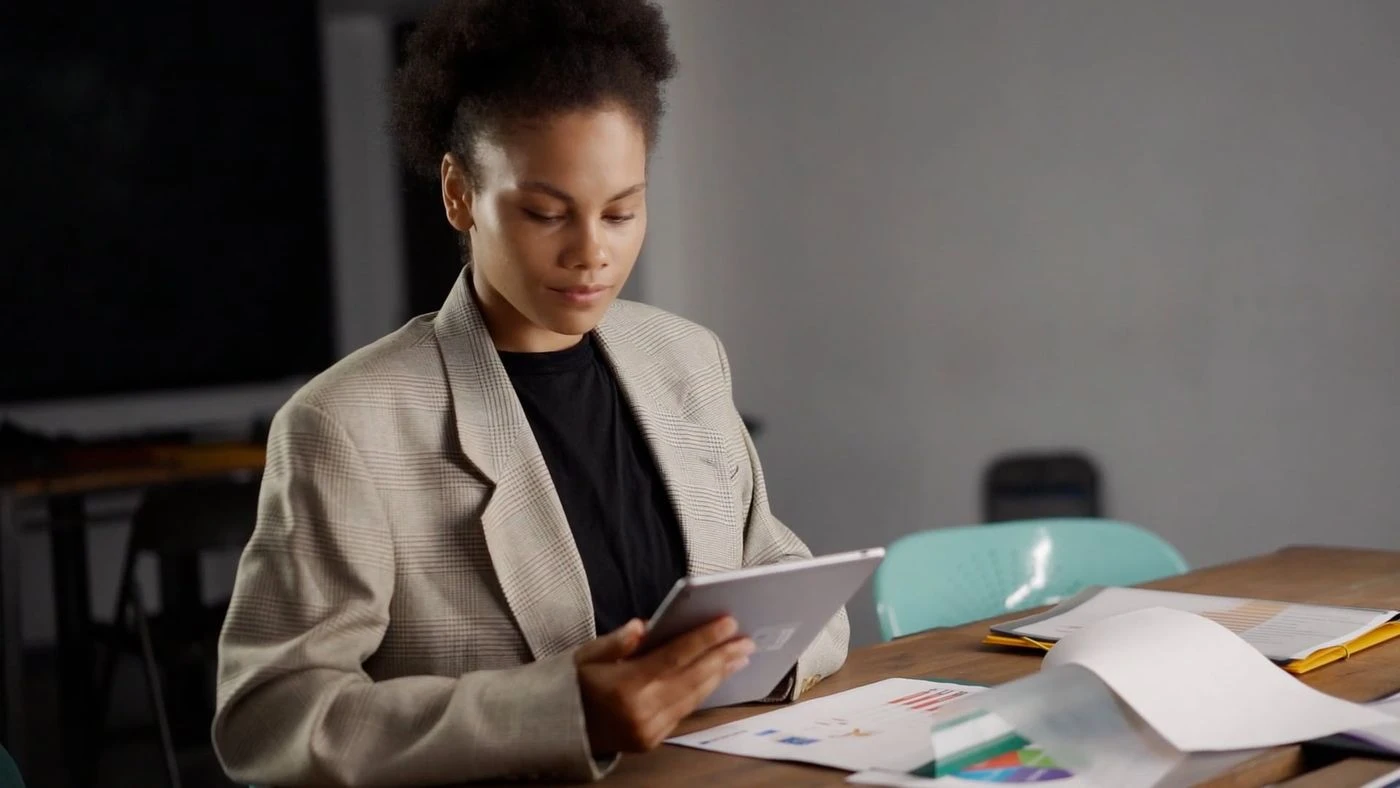 Professional reviewing business information on a tablet